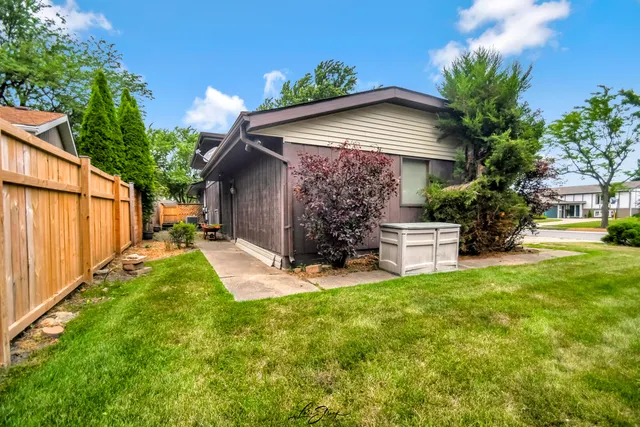 a view of a house with backyard and sitting area