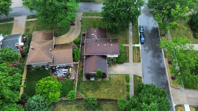 an aerial view of a house with outdoor space and a lake view