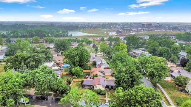 an aerial view of house with yard and ocean view