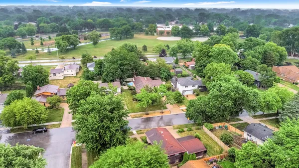 an aerial view of residential houses with outdoor space and river