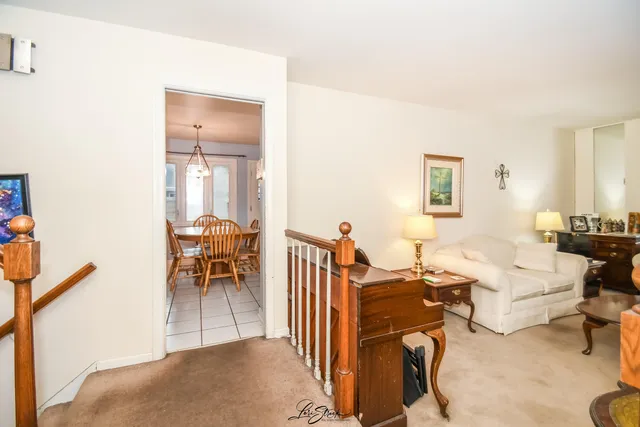 a living room with furniture a flat screen tv and a table
