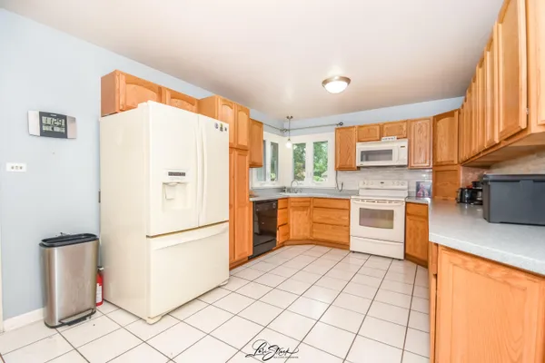 a kitchen with stainless steel appliances a refrigerator sink and microwave