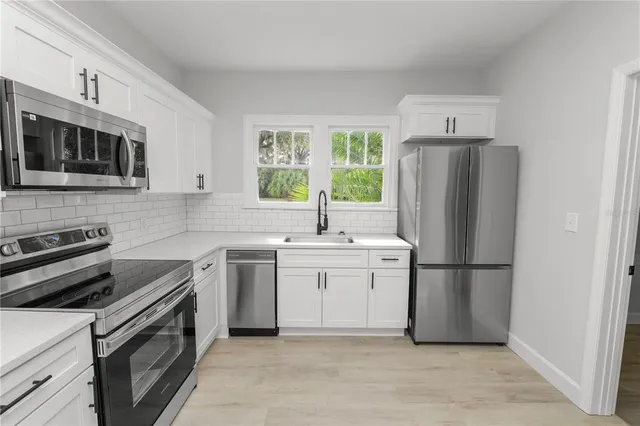 a kitchen with a sink stove and refrigerator
