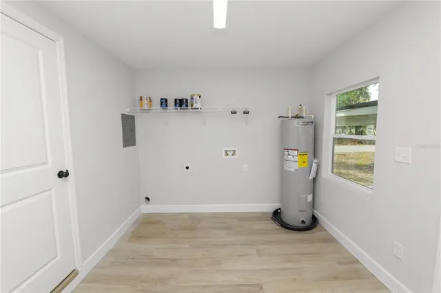 a view of empty room with window and tub