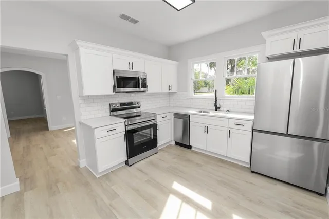 a kitchen with a refrigerator stove and microwave