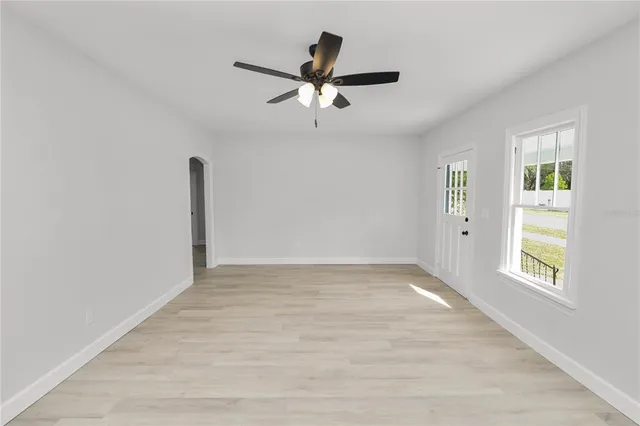 wooden floor in an empty room with a window