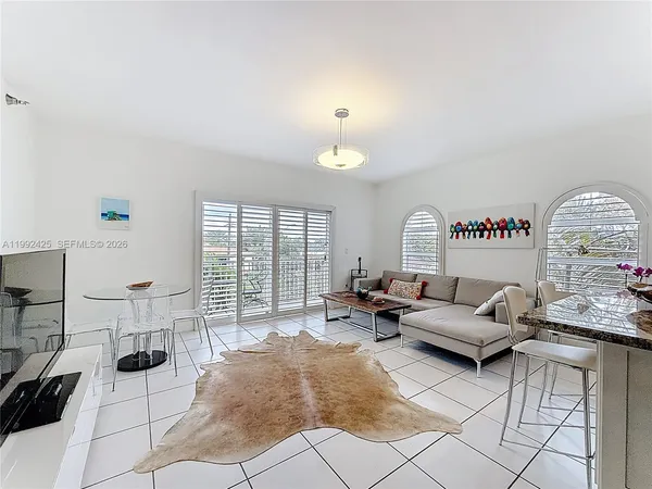 a living room with furniture and a large window