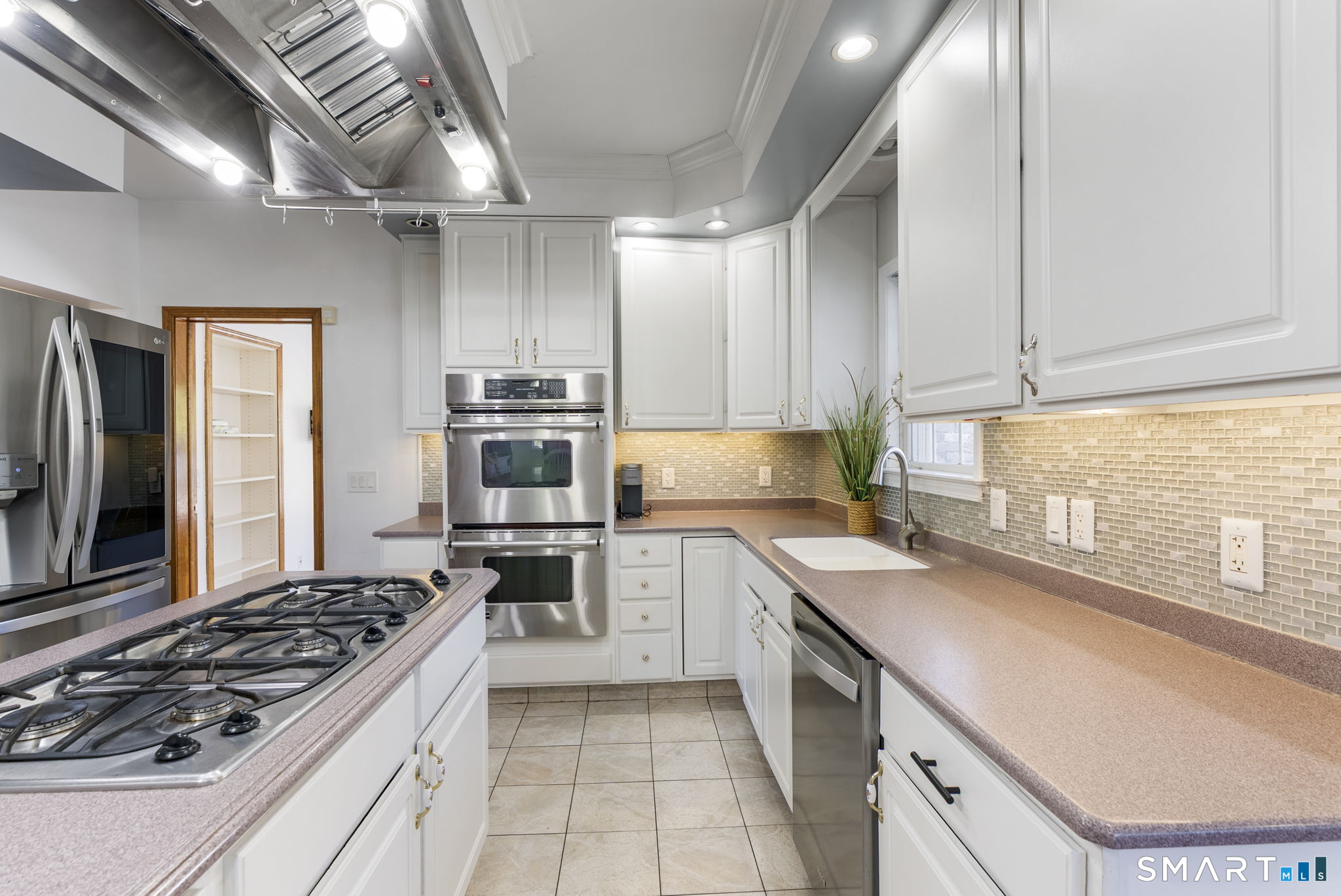 341 High Street Extension Thomaston, CT 06787 - Photo 8 of 39 a kitchen with a stove a sink and a refrigerator