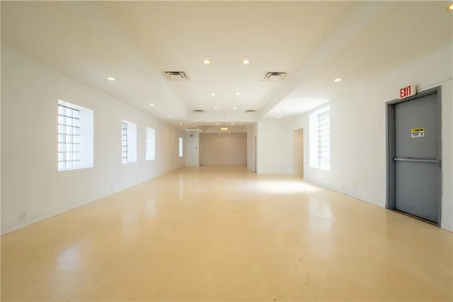 a living room with furniture a table and kitchen view
