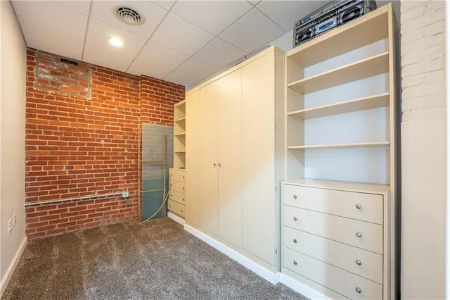 a view of a patio with couches table and chairs with wooden floor and fence