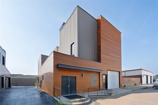 a living room with stainless steel appliances kitchen island granite countertop a stove and a refrigerator