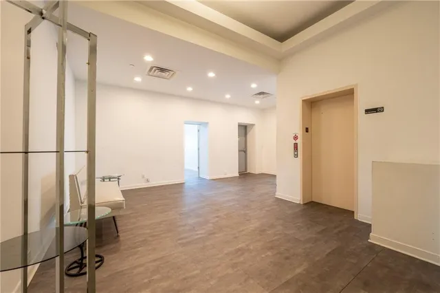 a living room with a large window and furniture