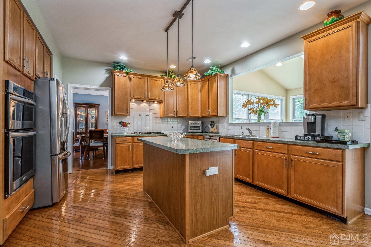 21 Rocky Hill Road Princeton, NJ 08540 - Photo 13 of 52 a kitchen with stainless steel appliances granite countertop wooden cabinets a sink a stove a dining table and chairs