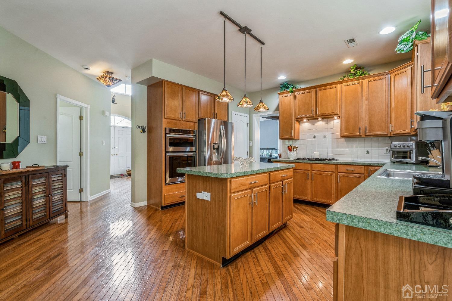 21 Rocky Hill Road Princeton, NJ 08540 - Photo 14 of 52 a large kitchen with stainless steel appliances granite countertop a stove a sink dishwasher and a refrigerator with wooden floor