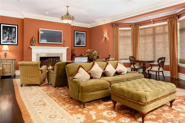a living room with furniture fireplace and a large window