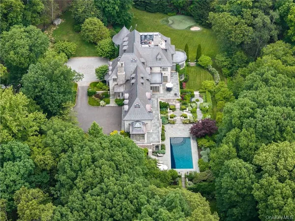 an aerial view of a house with a garden space and a street view