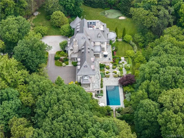 an aerial view of a house with a garden space and a street view