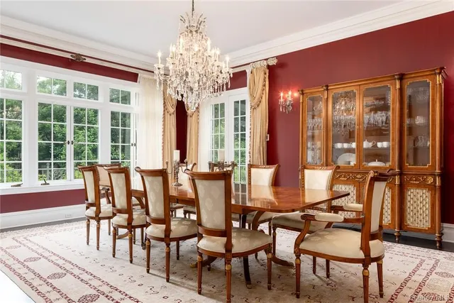 a dining room with furniture a chandelier and wooden floor