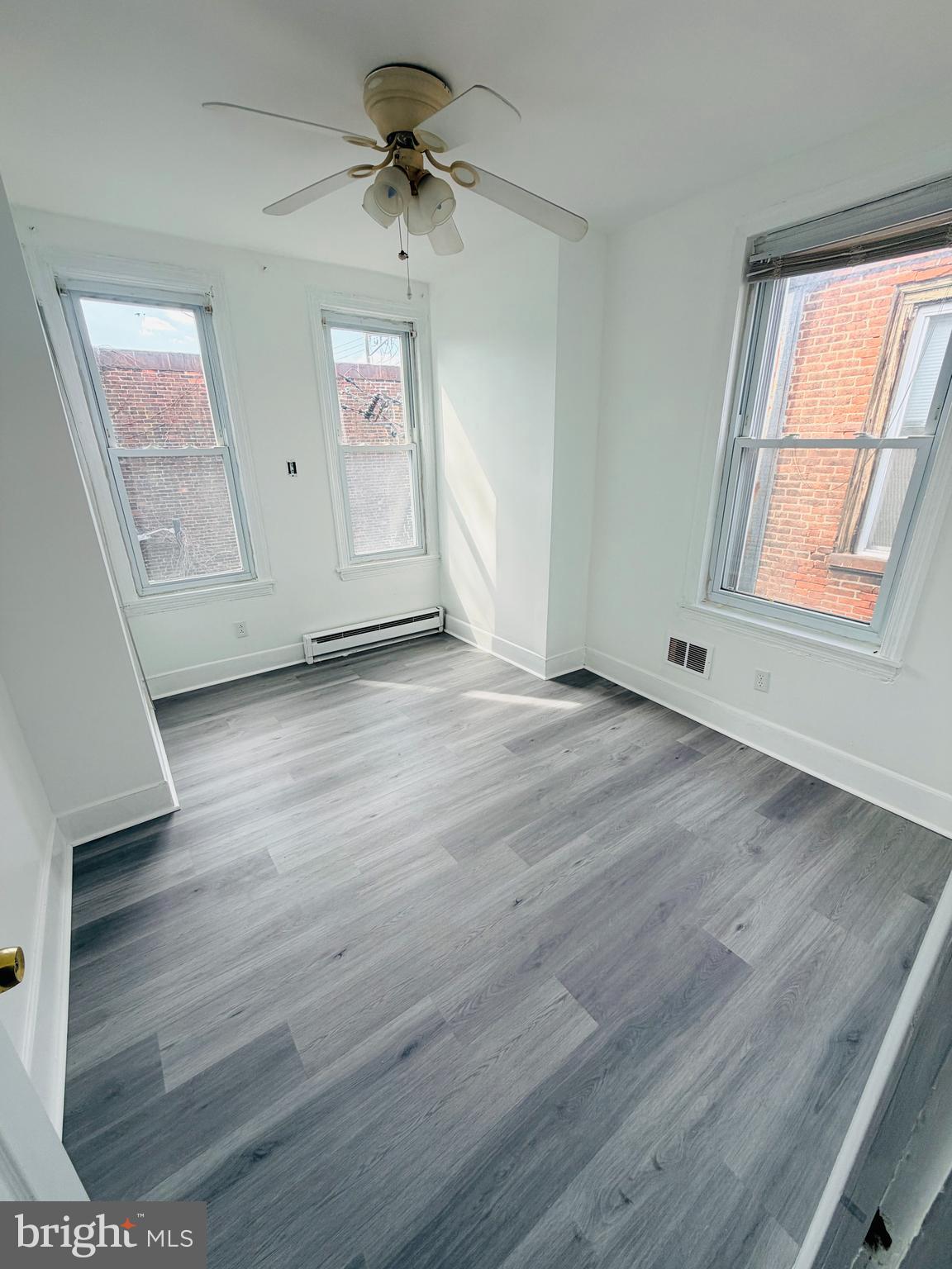 2260 North 15th Street Philadelphia, PA 19132 - Photo 10 of 12 wooden floor in an empty room with a window