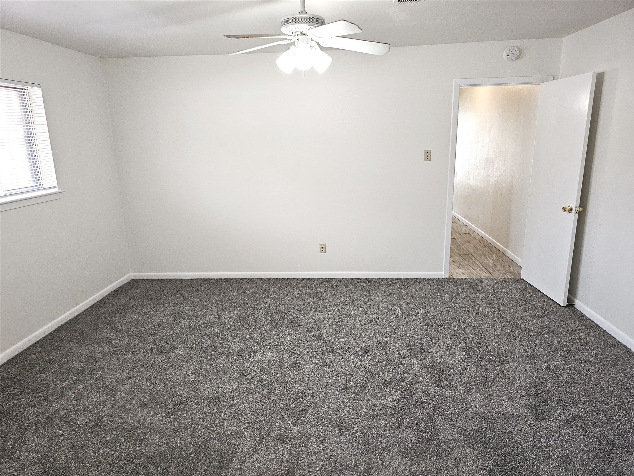 11427 Kirkmeadow Drive Houston, TX 77089 - Photo 16 of 24 an empty room with a window and a fan