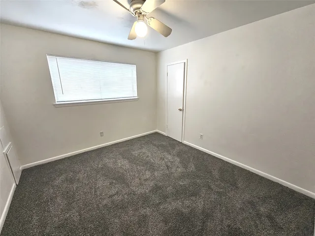 an empty room with a empty space and a ceiling fan