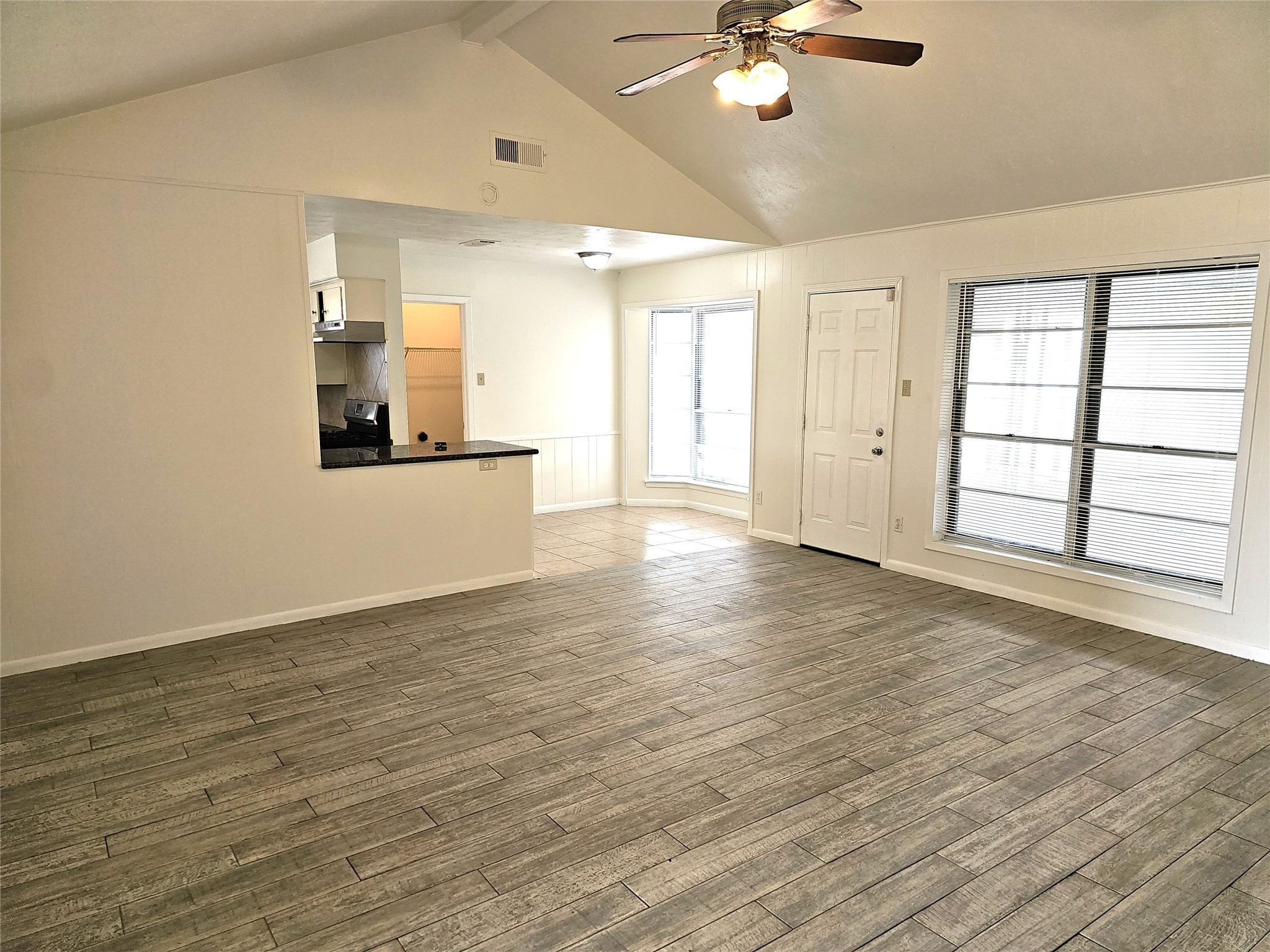 11427 Kirkmeadow Drive Houston, TX 77089 - Photo 3 of 24 a view of an empty room with a window and wooden floor
