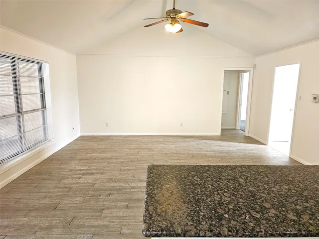 a kitchen with granite countertop a refrigerator and a stove