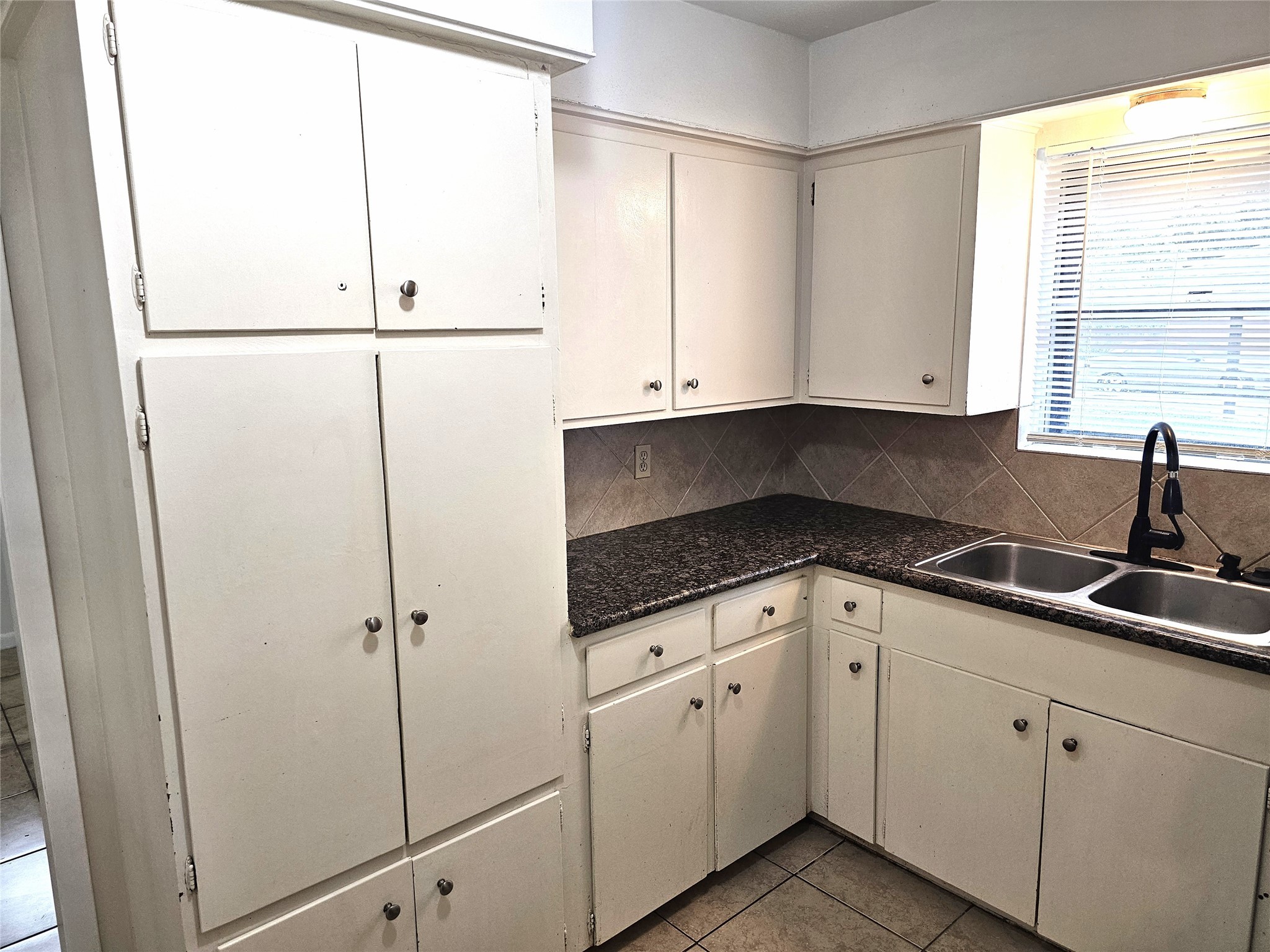 11427 Kirkmeadow Drive Houston, TX 77089 - Photo 9 of 24 a kitchen with white cabinets and white appliances