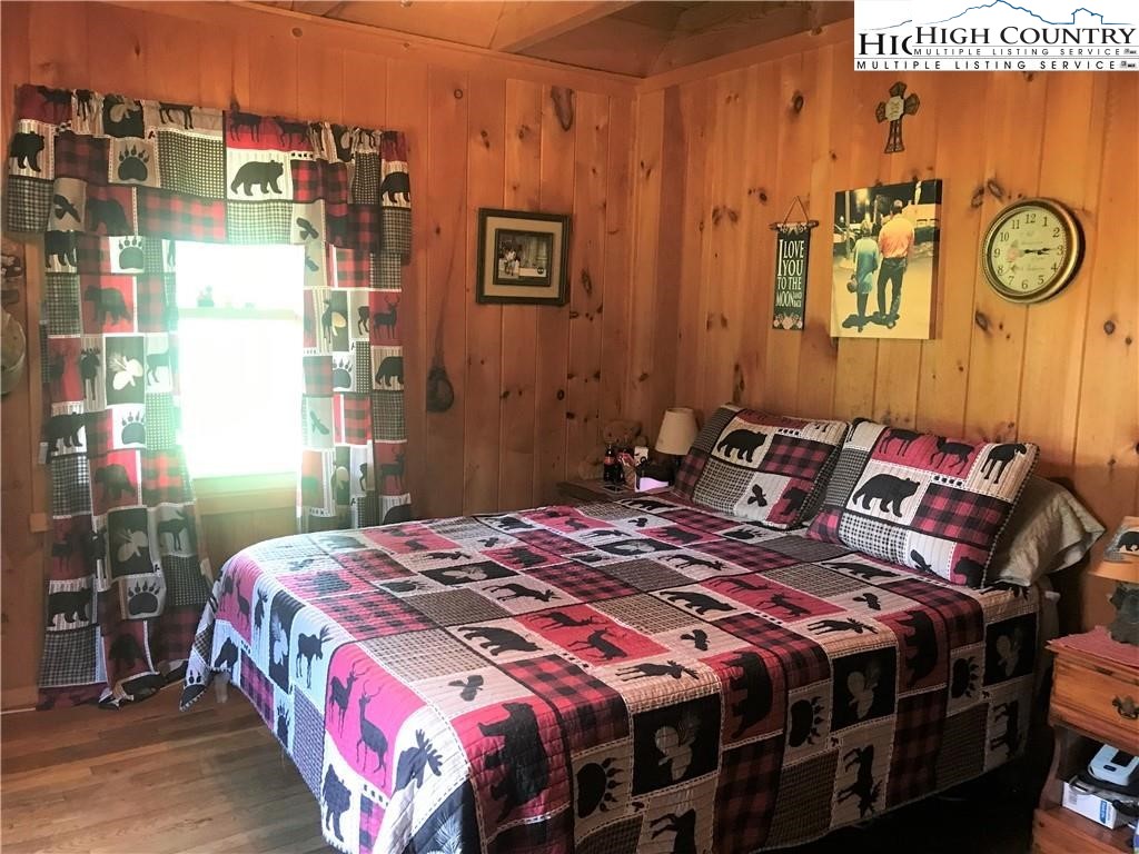 2232 Greer Town Road Lansing, NC 28643 - Photo 15 of 28 a bedroom with a bed and painting on the wall