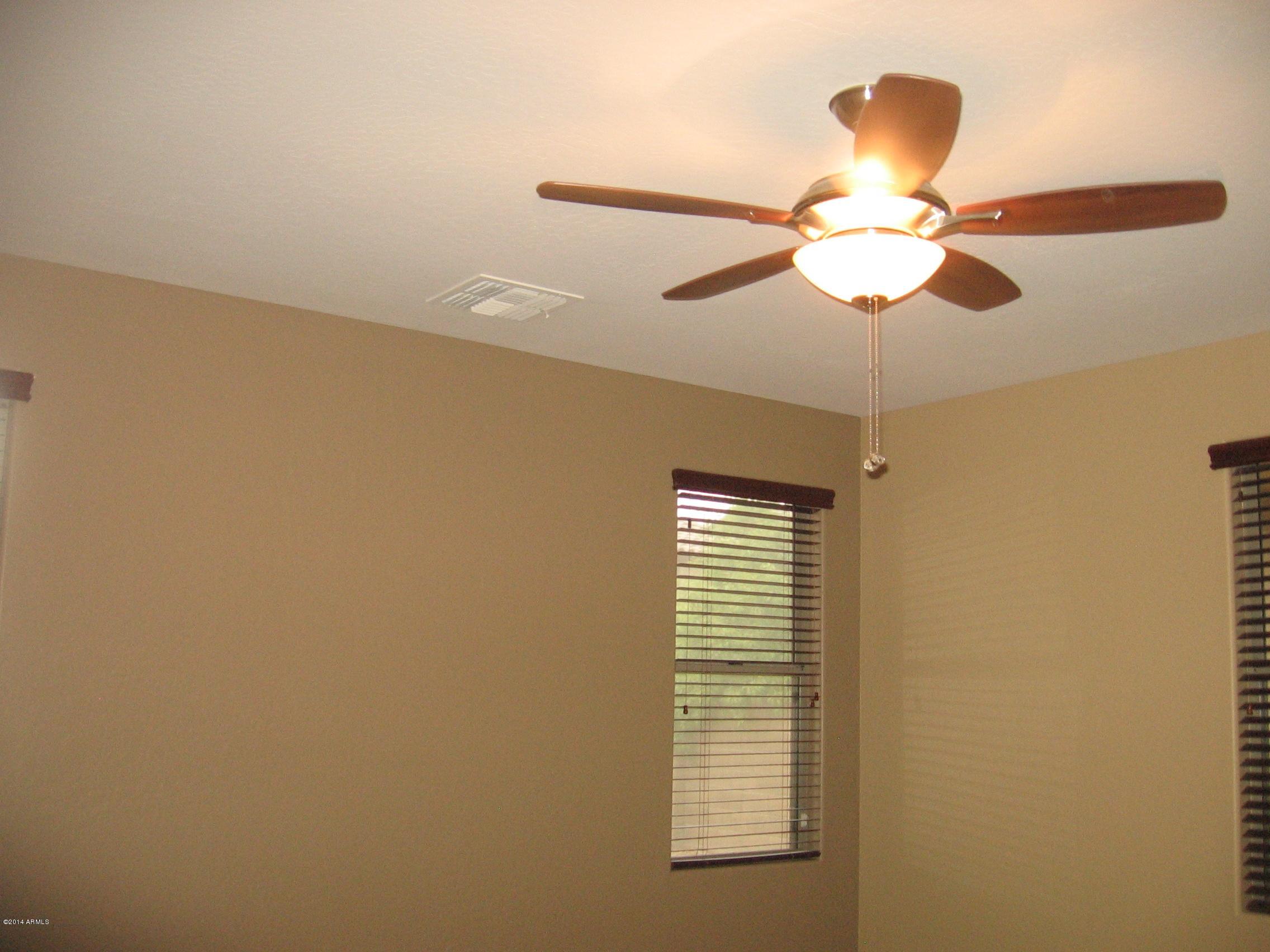 18022 West Hatcher Road Waddell, AZ 85355 - Photo 17 of 38 a view of a chandelier fan and a window