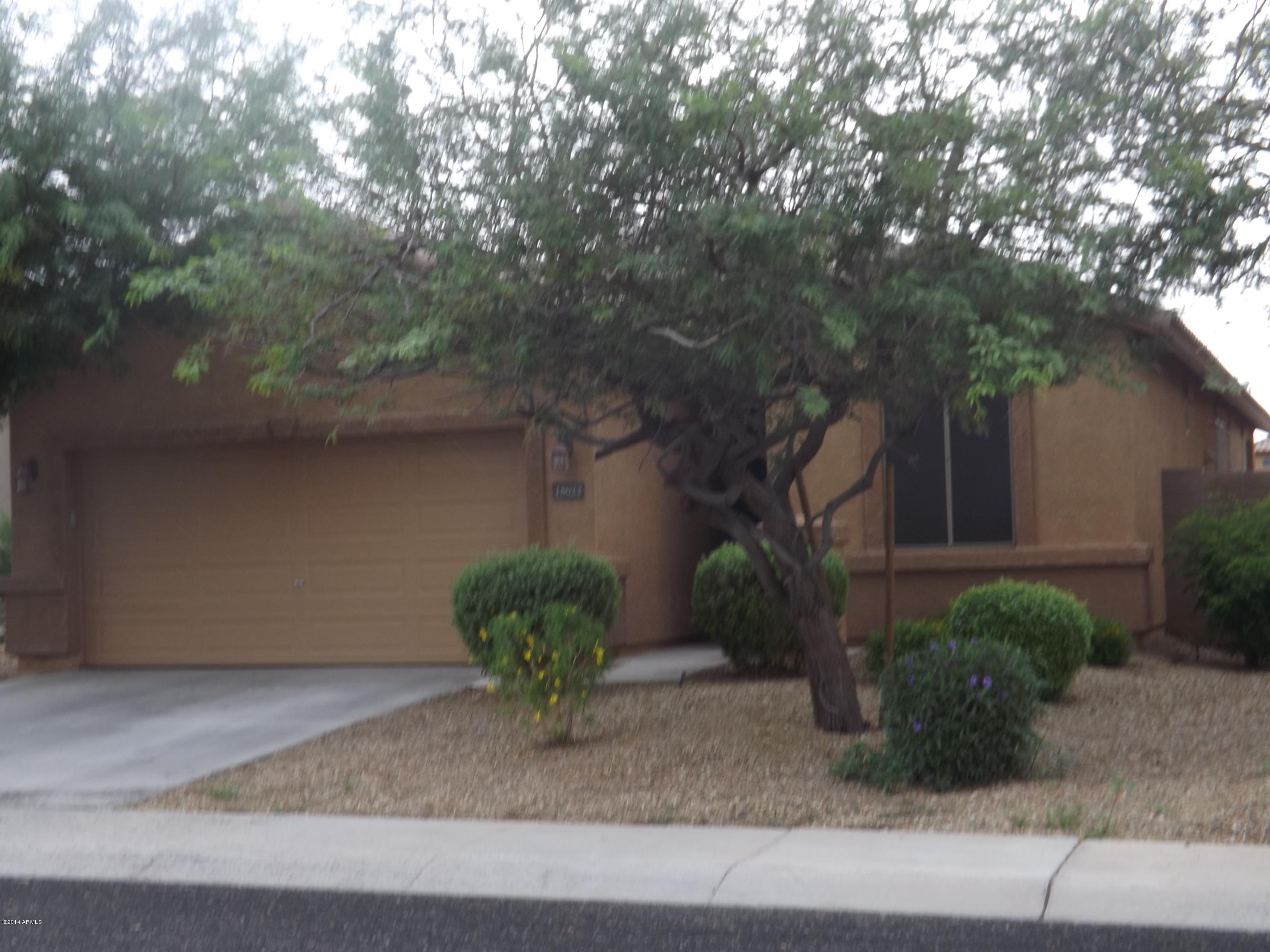 18022 West Hatcher Road Waddell, AZ 85355 - Photo 2 of 38 a front view of a house with garden