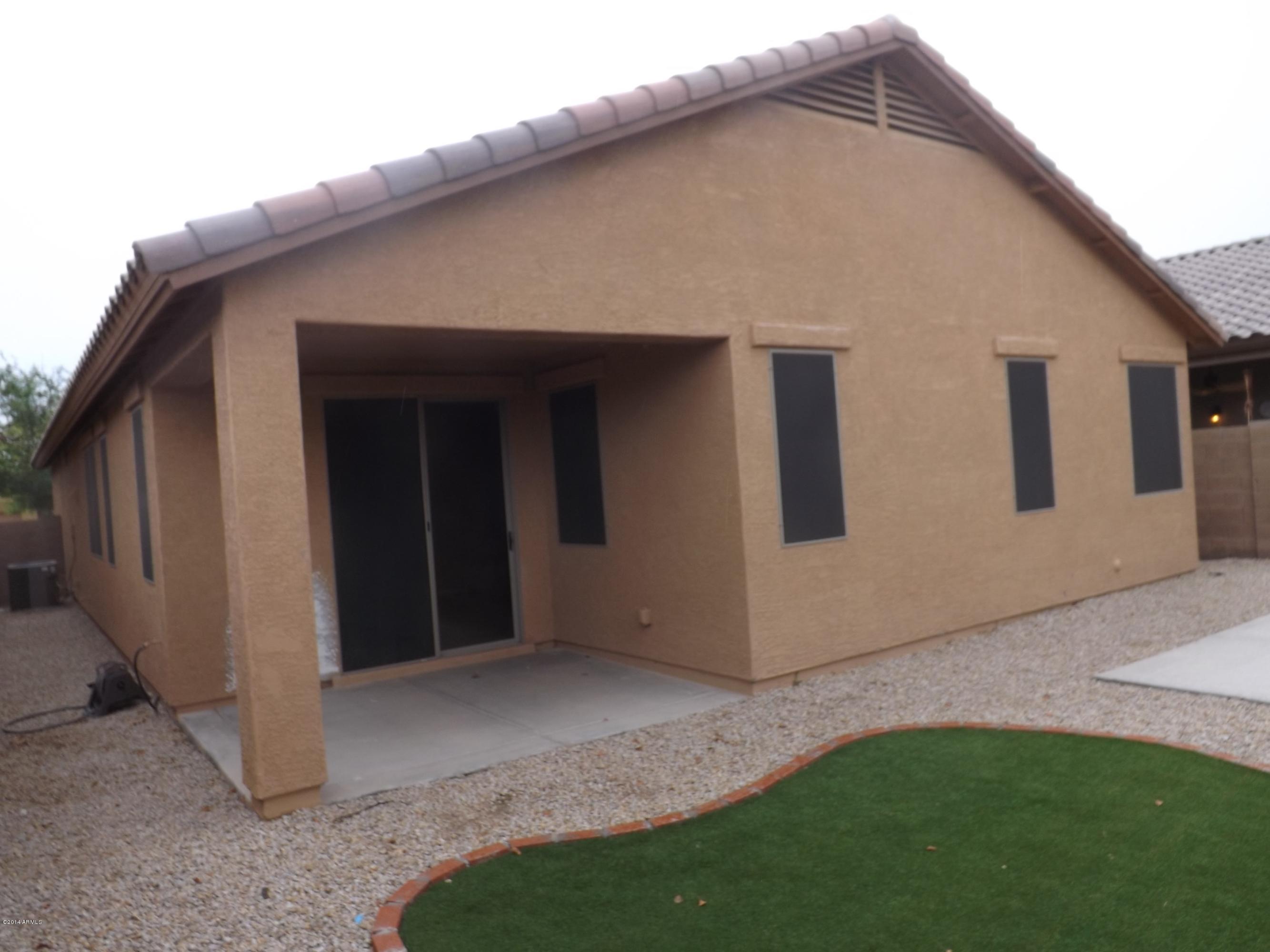 18022 West Hatcher Road Waddell, AZ 85355 - Photo 32 of 38 a backyard of a house with lots of green space