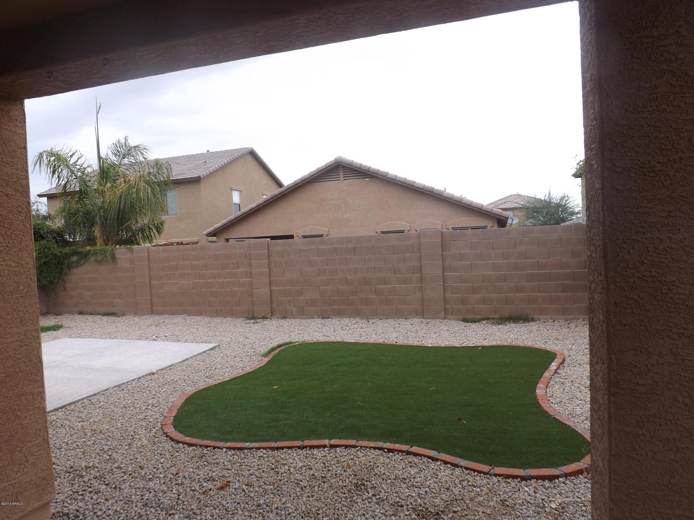 18022 West Hatcher Road Waddell, AZ 85355 - Photo 36 of 38 a view of a tiny house with a small yard