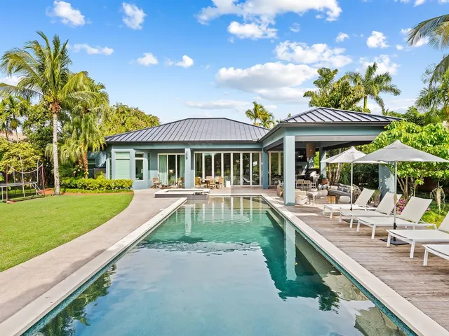 a view of a house with a yard patio and swimming pool