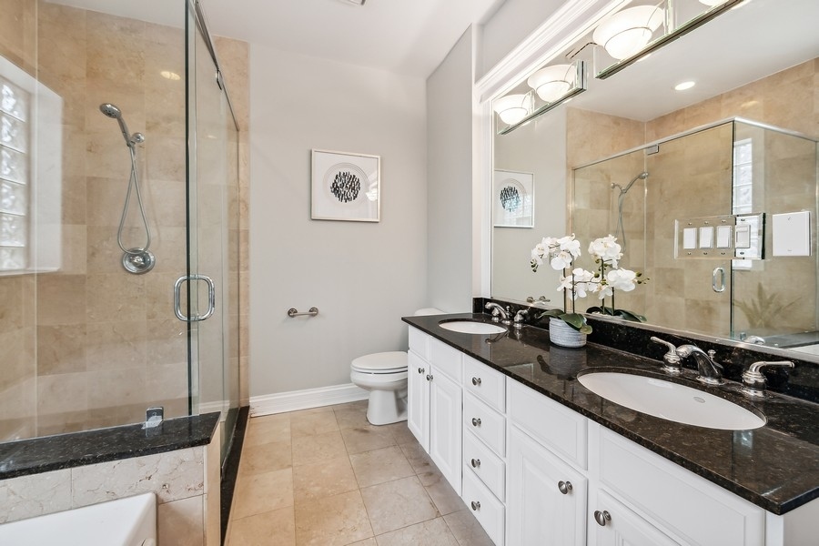 1359 North Mohawk Street, Unit 2 Chicago, IL 60610 - Photo 14 of 23 a bathroom with a granite countertop sink mirror and a bathtub