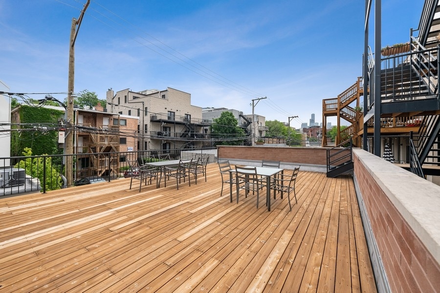 1359 North Mohawk Street, Unit 2 Chicago, IL 60610 - Photo 22 of 23 a view of a rooftop with chairs and wooden floor