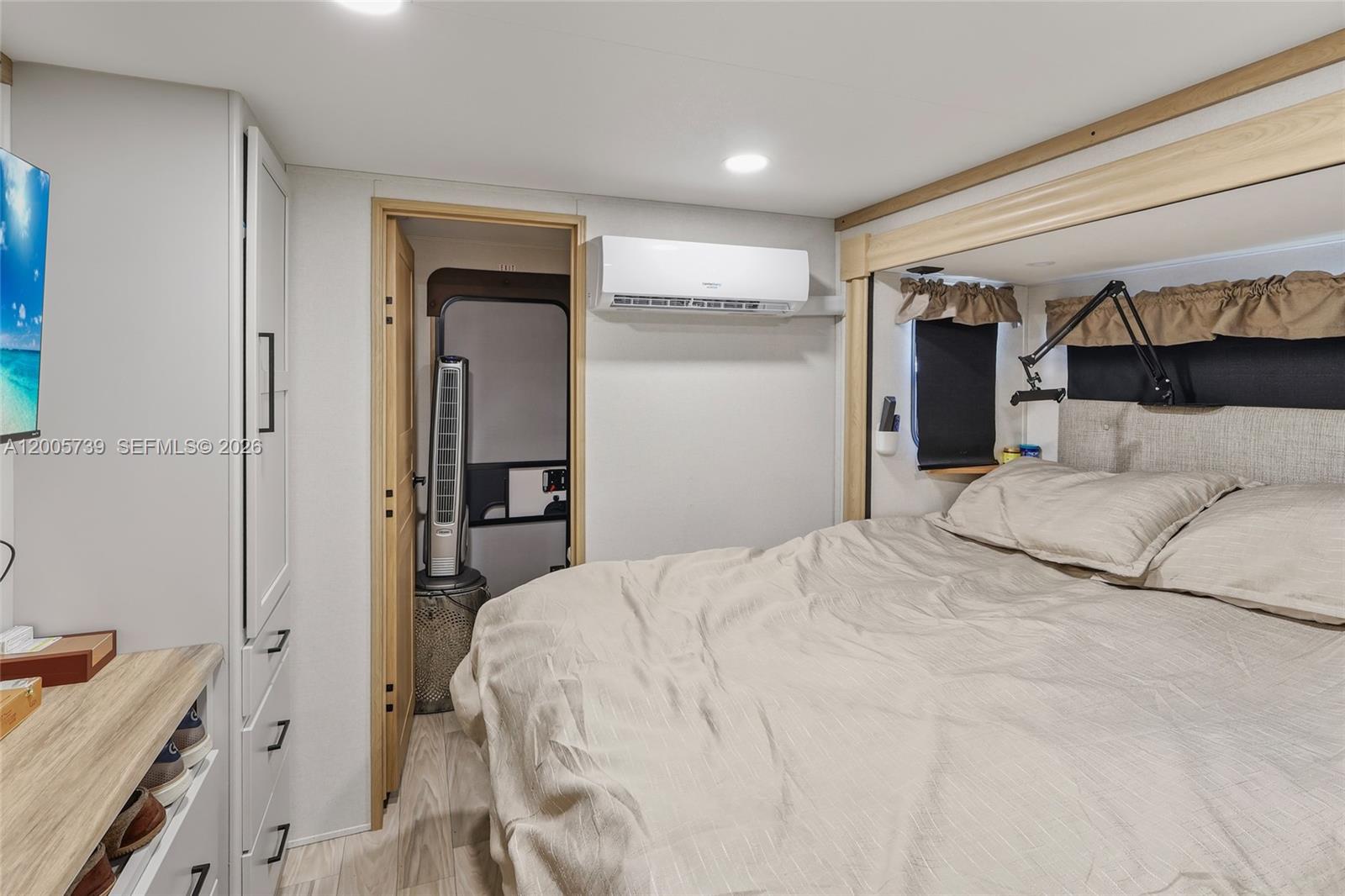 325 Calusa Street, Unit 312 Key Largo, FL 33037 - Photo 13 of 21 a bedroom with a bed and a lamp on dresser