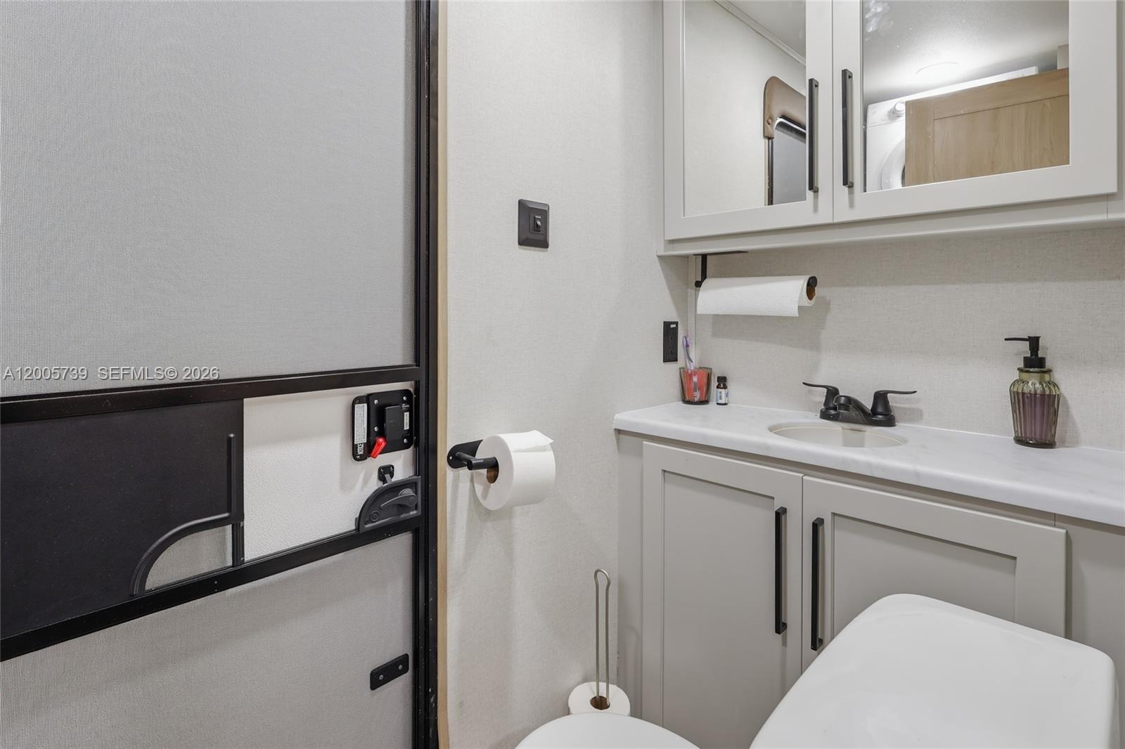 325 Calusa Street, Unit 312 Key Largo, FL 33037 - Photo 14 of 21 a bathroom with a sink and a mirror