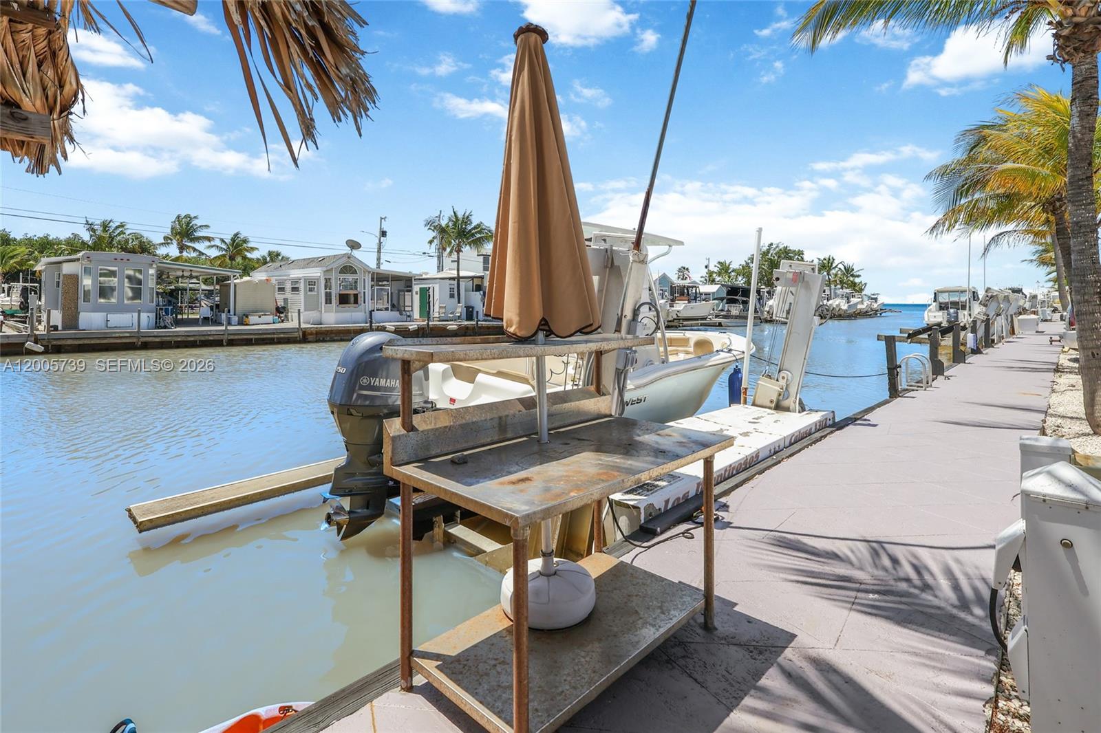 325 Calusa Street, Unit 312 Key Largo, FL 33037 - Photo 16 of 21 a view of a patio with a table chairs and barbeque grill
