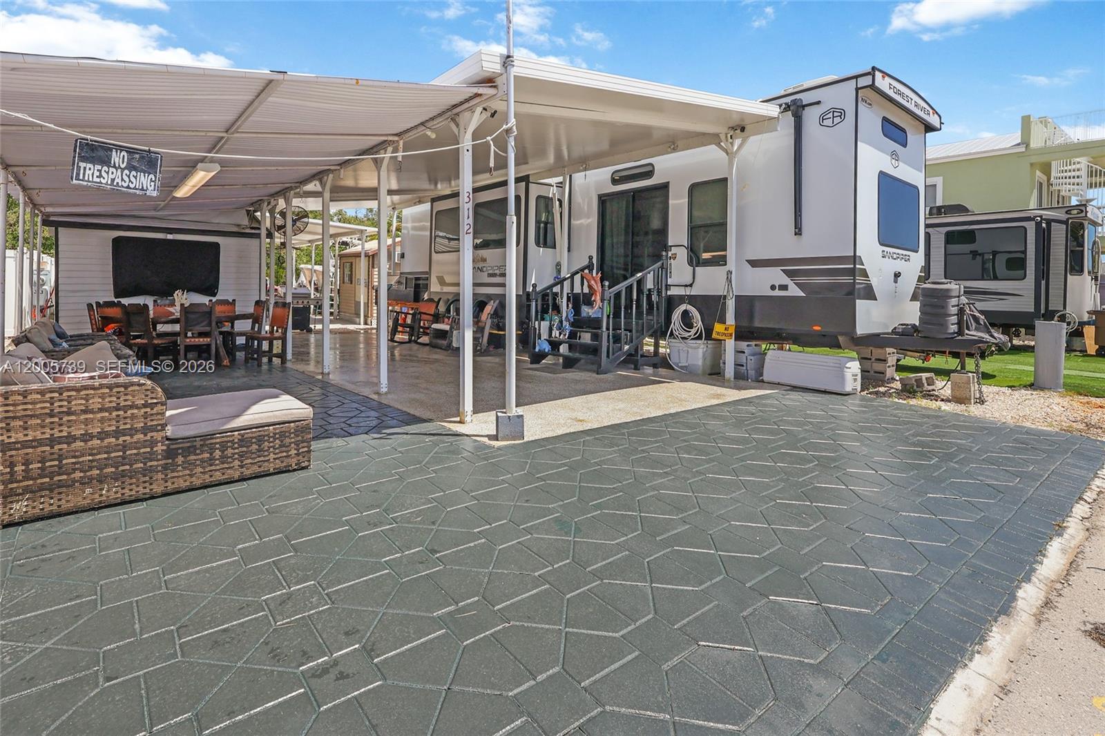 325 Calusa Street, Unit 312 Key Largo, FL 33037 - Photo 3 of 21 a view of a patio with a table and chairs