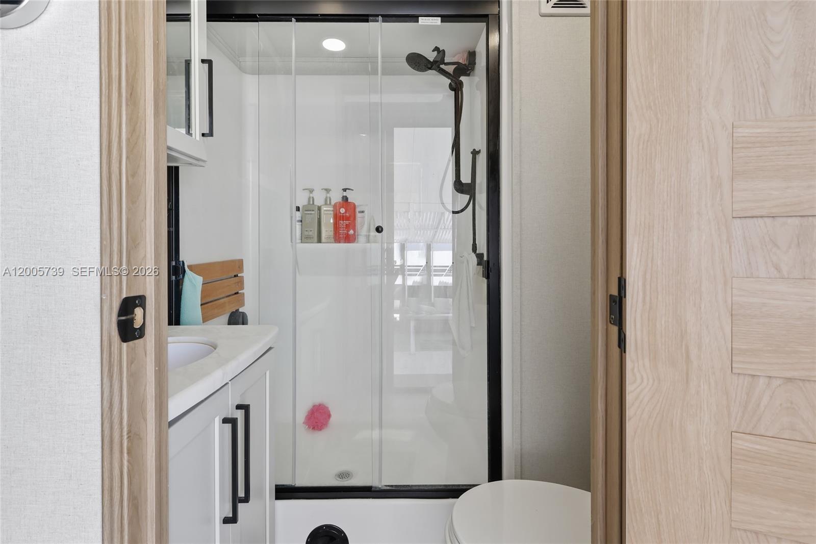 325 Calusa Street, Unit 312 Key Largo, FL 33037 - Photo 8 of 21 a bathroom with a shower and a mirror