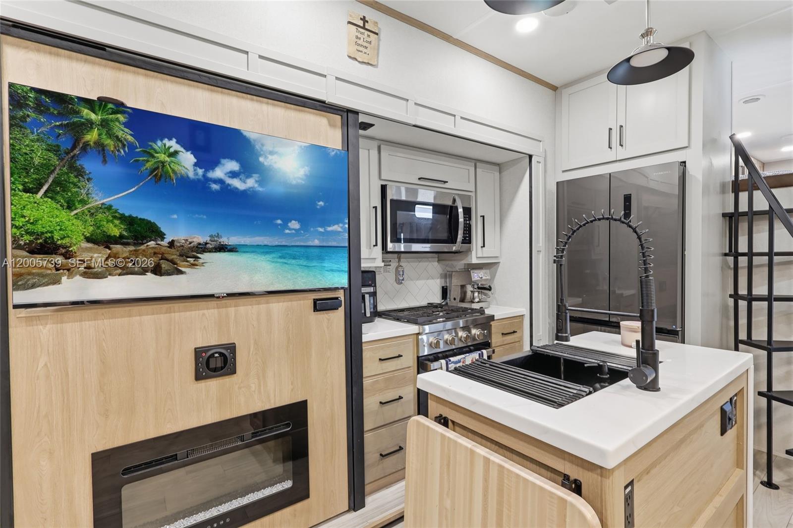 325 Calusa Street, Unit 312 Key Largo, FL 33037 - Photo 10 of 21 a kitchen with stainless steel appliances granite countertop a stove a refrigerator and a microwave