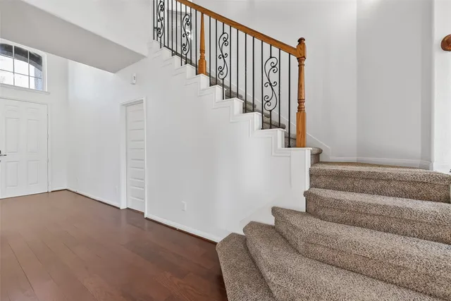 a view of a livingroom with wooden floor and a ceiling fan