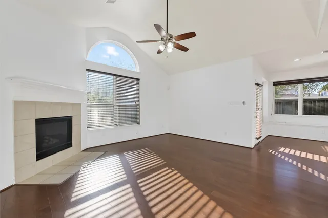 a kitchen with stainless steel appliances granite countertop a stove top oven a sink dishwasher and a refrigerator with wooden floor