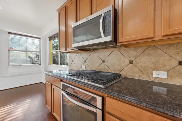 a view of a backyard with a garden and deck