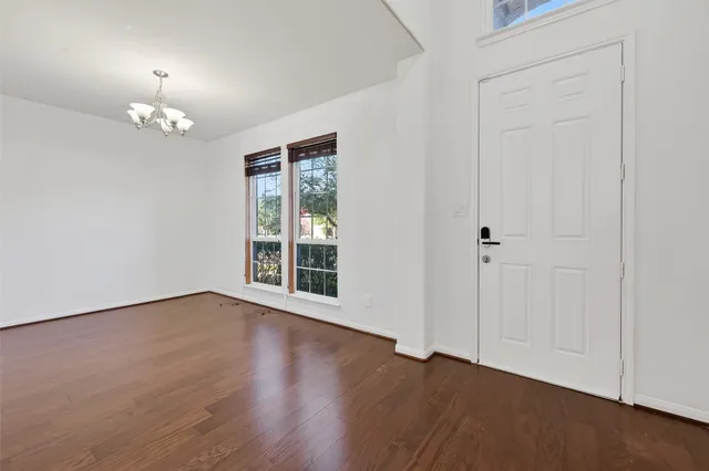 a view of an empty room with a chandelier