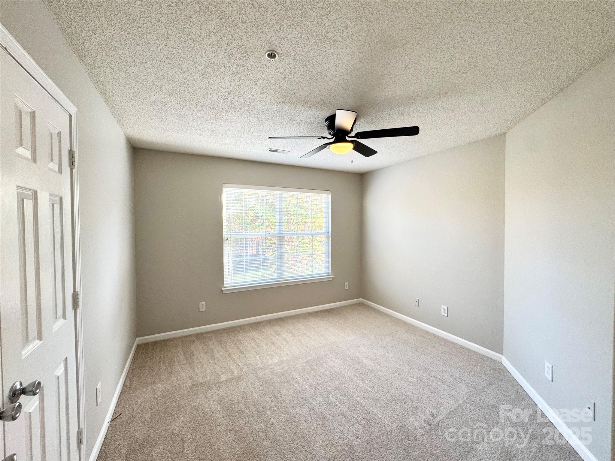 327 Flint Hill Road, Unit 203 Fort Mill, SC 29715 - Photo 13 of 18 a view of an empty room with a window