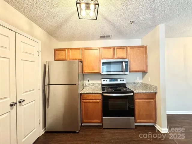 a kitchen with a refrigerator stove and microwave