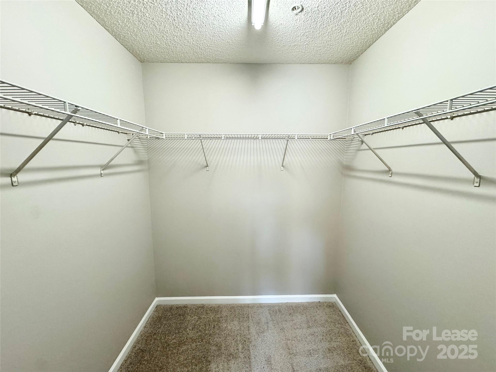 327 Flint Hill Road, Unit 203 Fort Mill, SC 29715 - Photo 10 of 18 a view of a room with racks on the wall