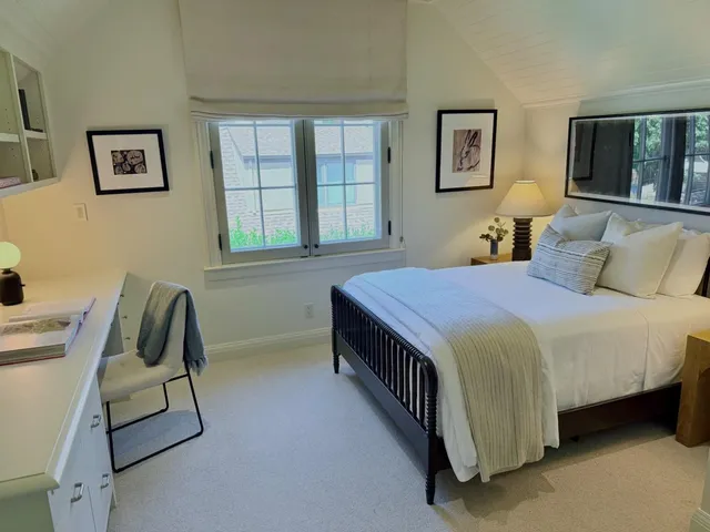 a bedroom with a bed chair and window